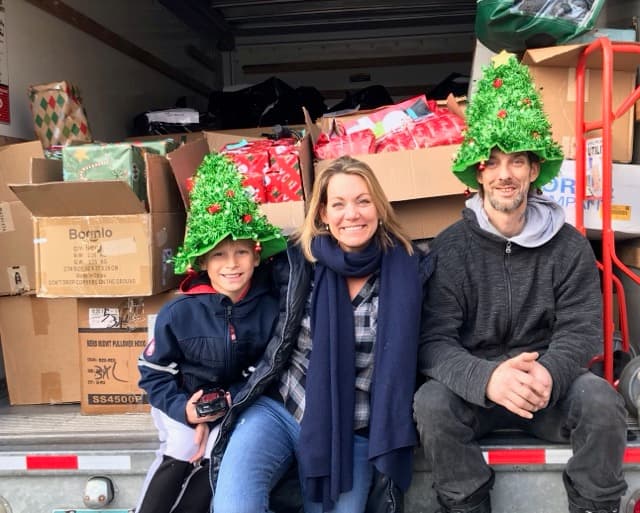 Volunteers loading gifts into a truck